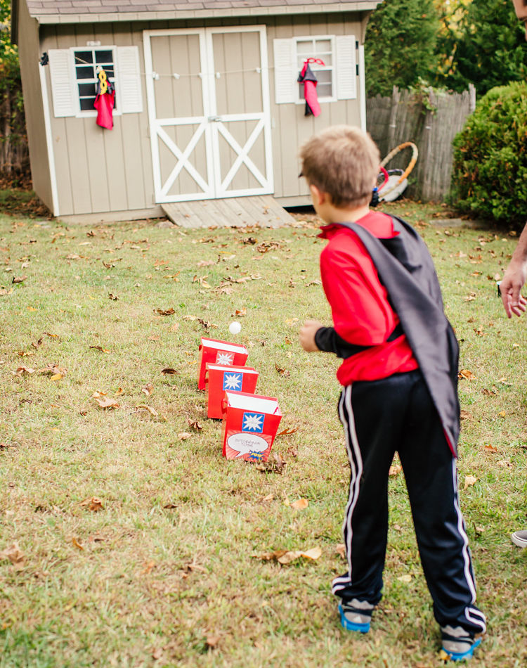 A fantastic superhero party game is a Green Goblin Ball Toss! Featuring SIMONEmadeit Party Printables https://www.simonemadeit.com/superhero-birthday-party/